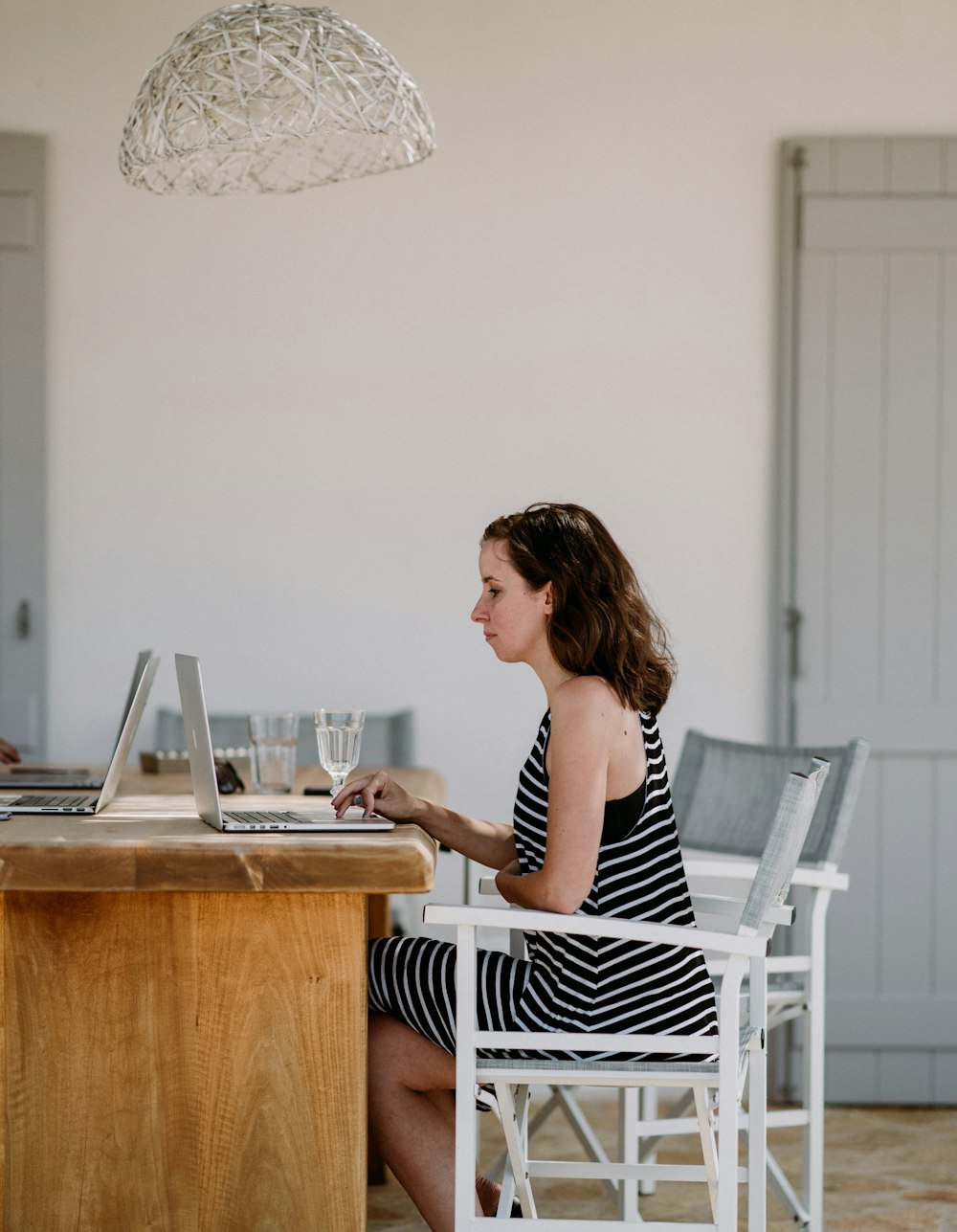 woman sitting on chair while using MacBook