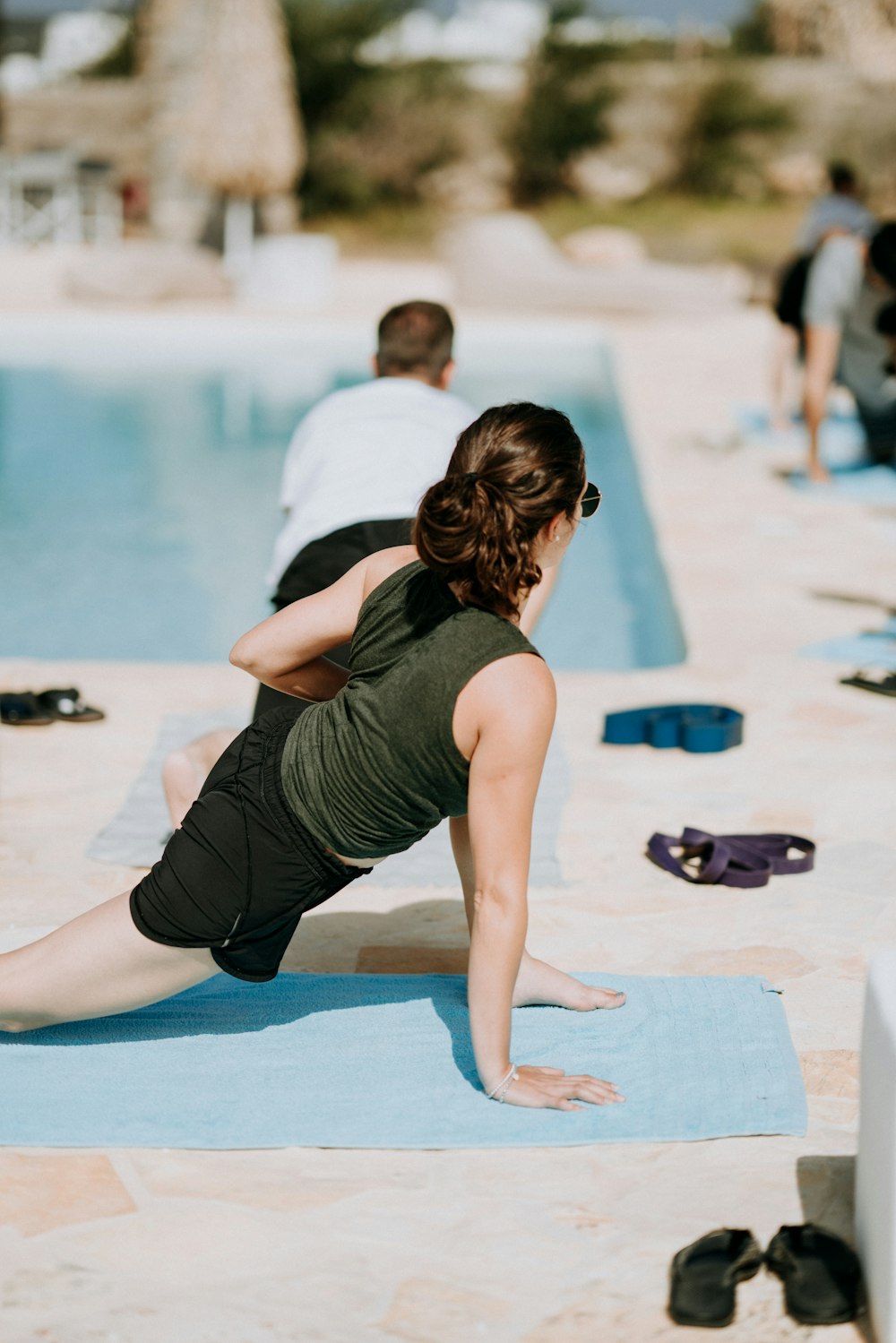 woman wearing black tank shirt near the pool