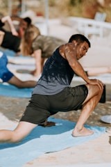 A vibrant woman stretching outdoors at sunrise, embodying energy and focus.