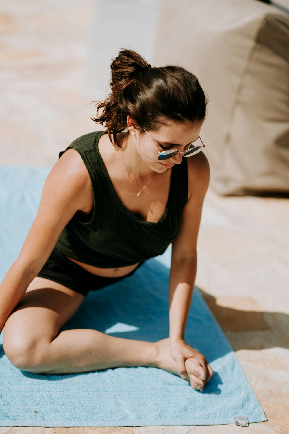woman doing exercise on blue yoga mat