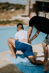 A professional physiotherapist guiding a patient through gentle exercises in a modern clinic.