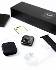 Fitness accessories like smartwatches and resistance bands arranged on a clean surface.