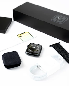 Fitness accessories like smartwatches and resistance bands arranged on a clean surface.