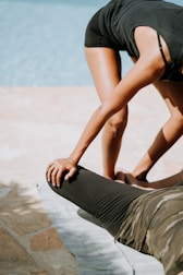 A therapist assisting a client with gentle stretching exercises to enhance mobility.