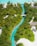 Aerial view of a vibrant tropical landscape featuring a winding turquoise stream bordered by lush green palm trees and vegetation. Sandy white pathways and a few buildings with thatched roofs are nestled within the greenery, and a small bridge crosses the stream.