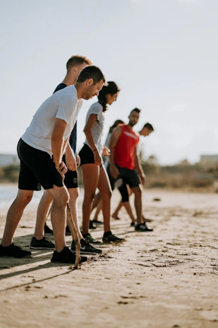 A group of friends stretching before a workout, all dressed in matching Opalum activewear.