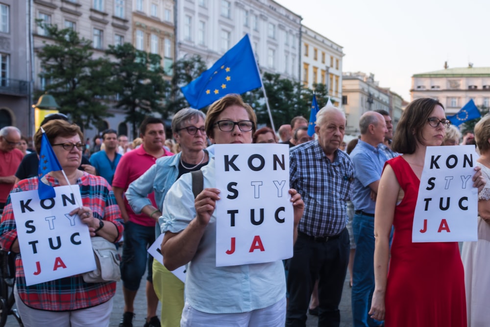 people rallying on road near buildings