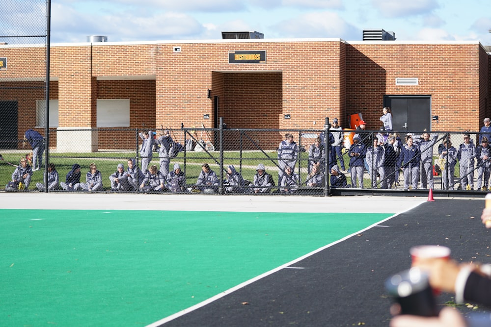 people behind of gray fence