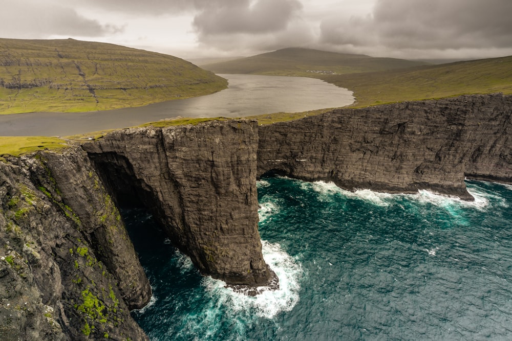 aerial photographyof cliff near body of water