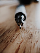 Close-up of a vintage pen being carefully restored by hand in a minimalist studio.