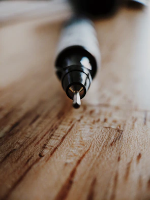 A close-up of a polished résumé and a pen resting on a modern desk.