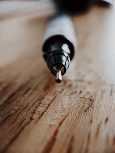Close-up of a high-quality pen resting on a smooth notebook surface.