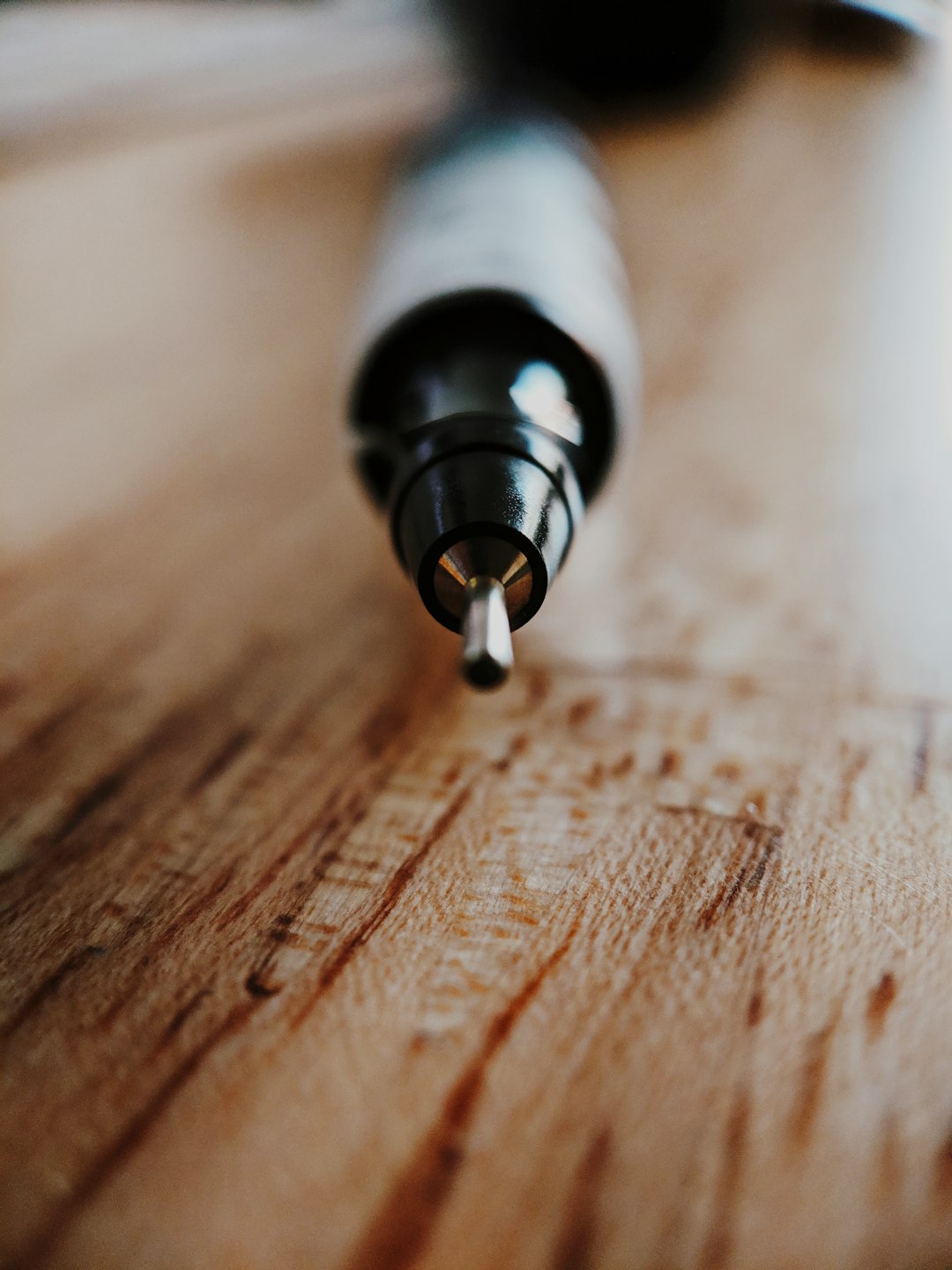selective focus photography of pen tip