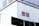A large building facade with a prominent red and white UNIQLO logo displayed on its wall. Below the logo are several banners with brand names and imagery, suggesting a commercial area.