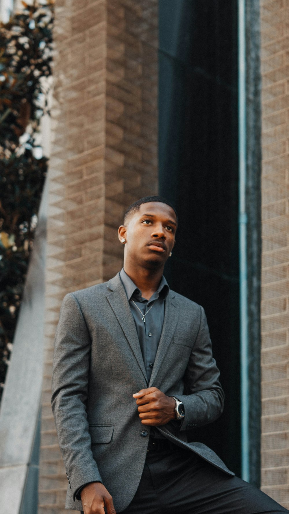 man wearing grey suit jacket during daytime