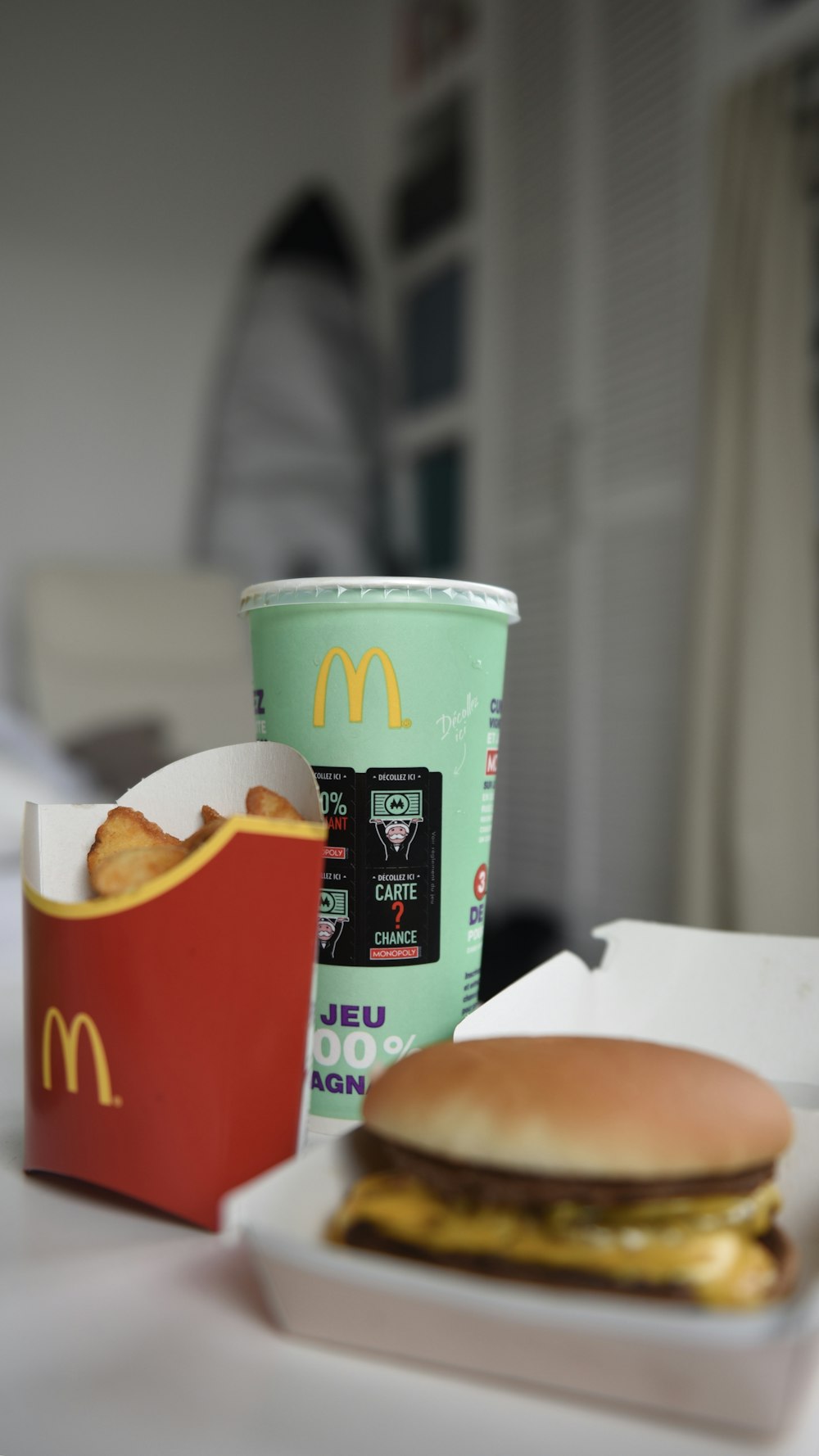 McDonald burger, fries, and soda on desk