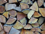 Stack of premium firewood logs neatly arranged on a rustic wooden pallet.