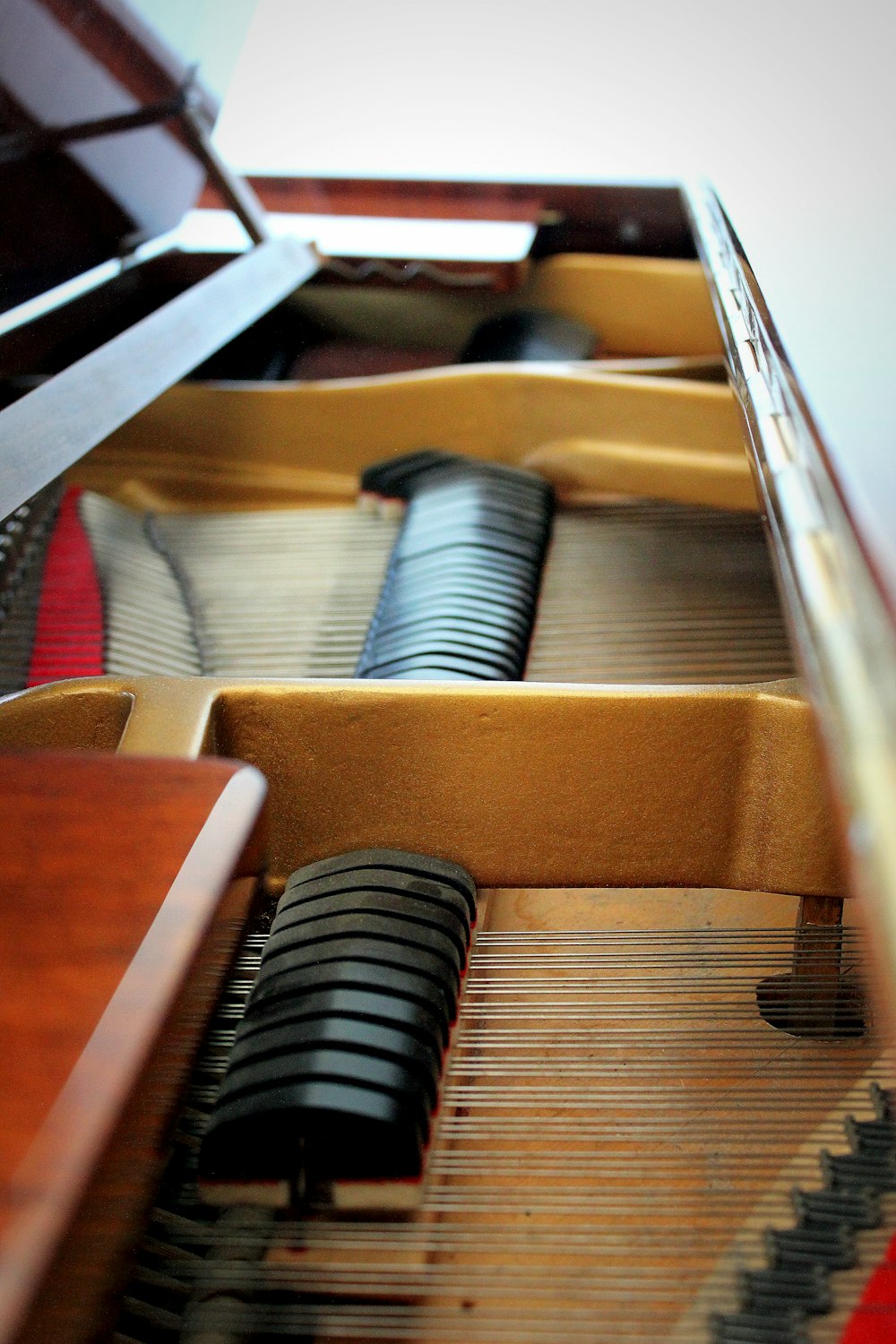 a close up of a piano with a wooden case