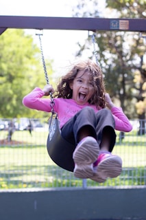 A young girl playing softball with determination and joy.