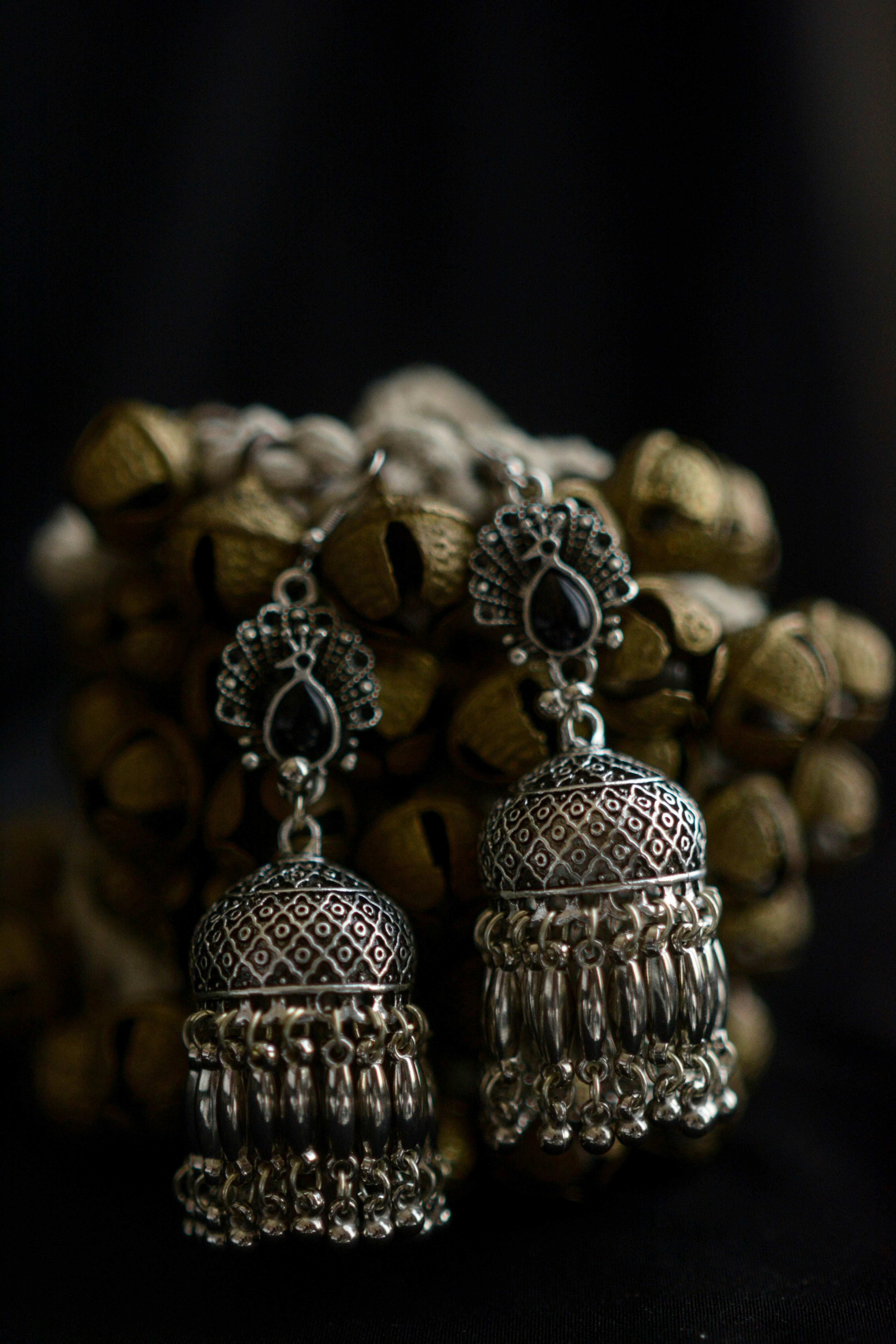 Traditional silver jhumka earrings with intricate detailing