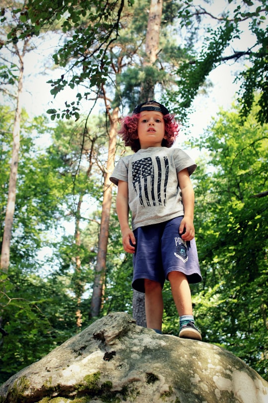 boy standing on rock in Fontainebleau France