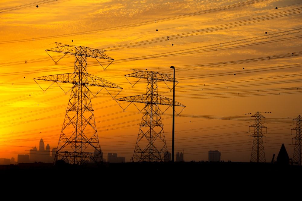 several transmission towers during golden hour