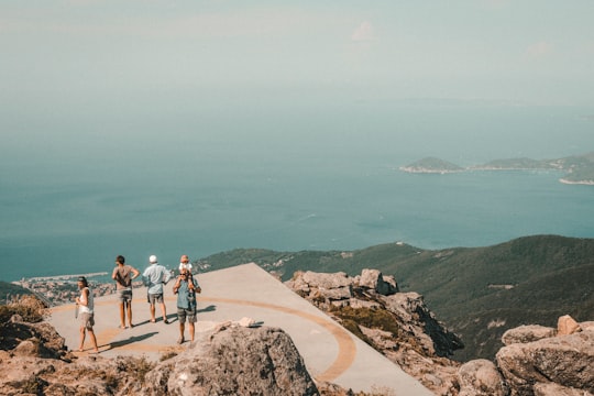 peoples standing on mountain in Tuscan Archipelago National Park Italy