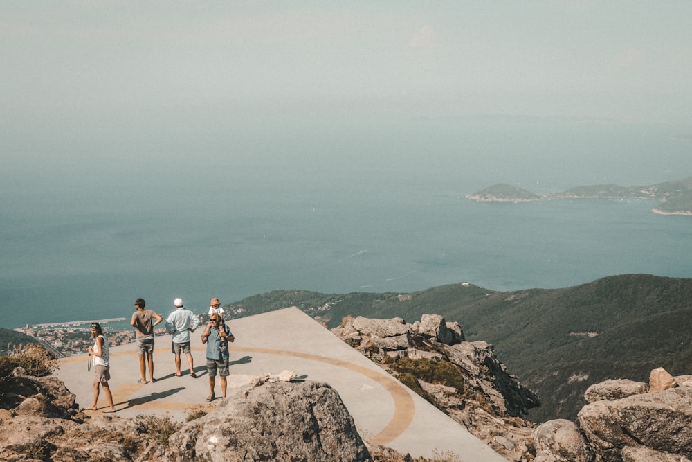 peoples standing on mountain