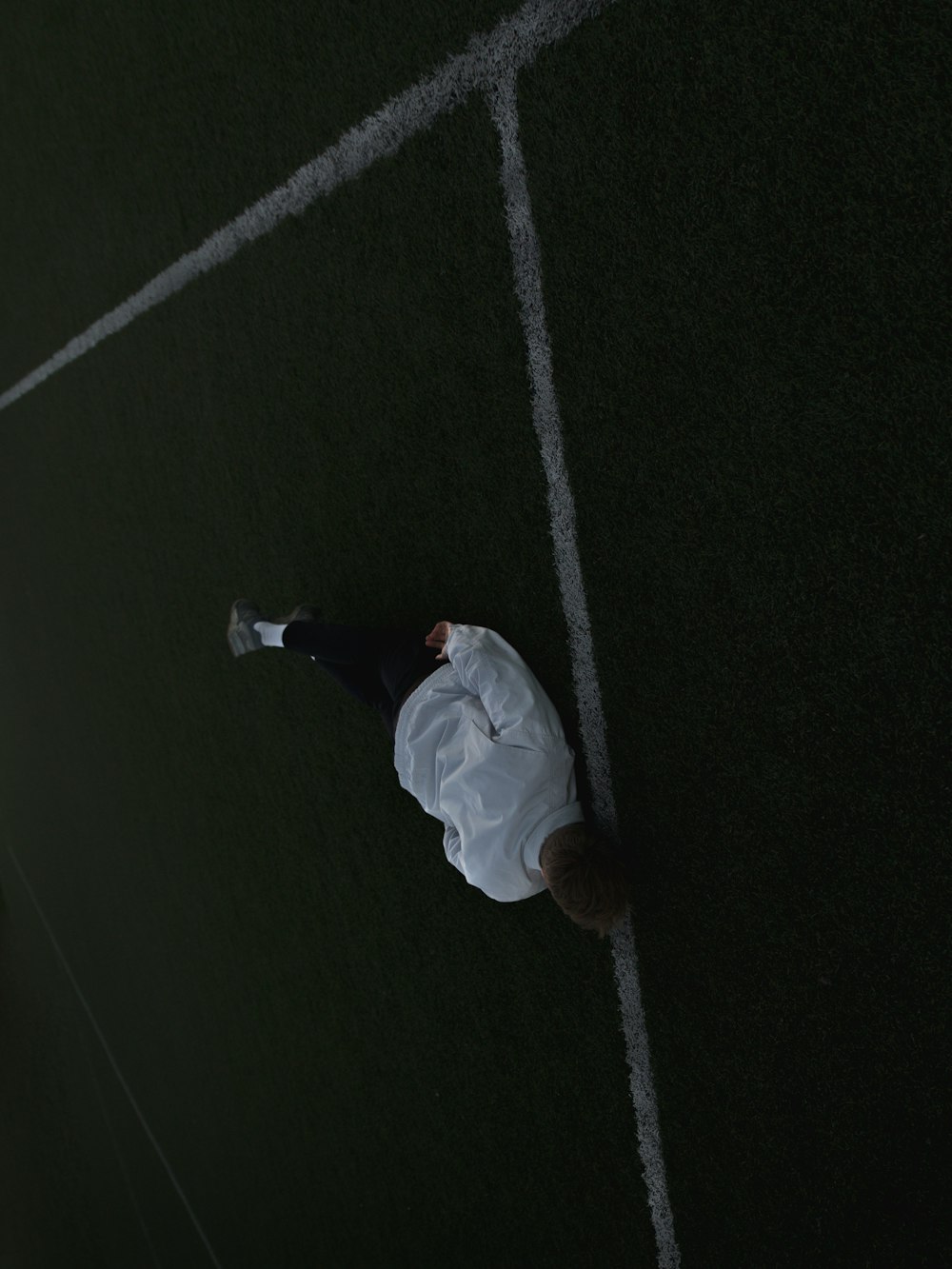 man lying on football field