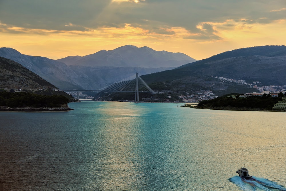 calm body of water near mountains