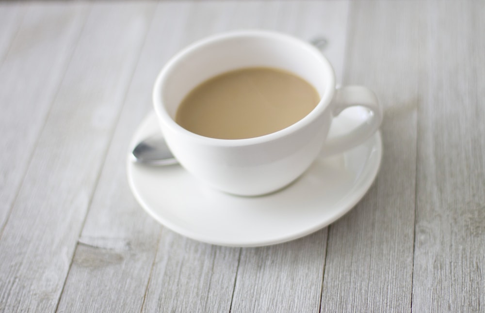 white teacup on saucer