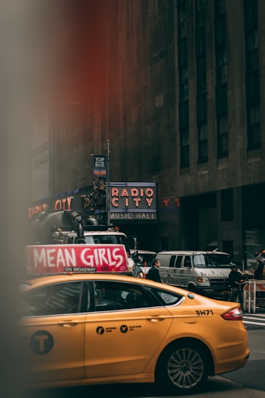 yellow sedan near building