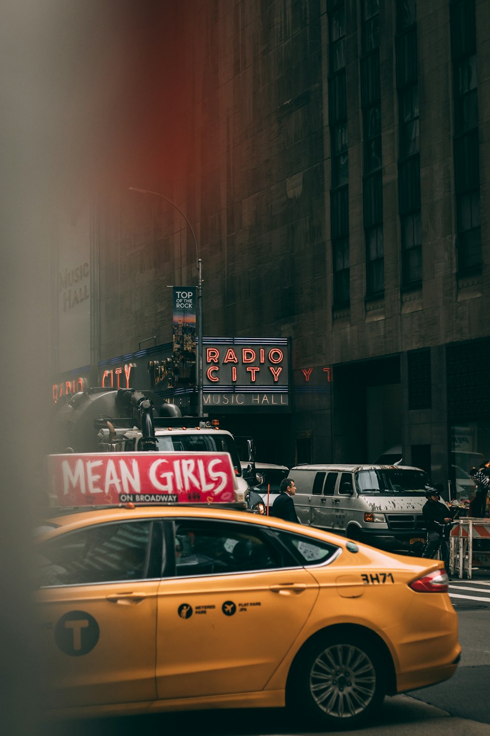 yellow sedan near building