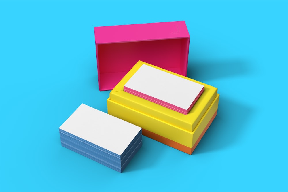 a group of three different colored boxes on a blue background