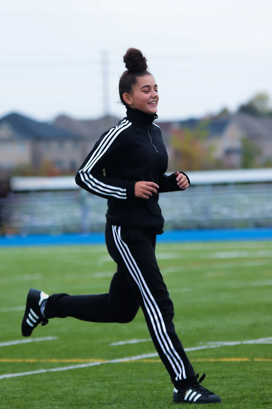Runner in a black track set sprinting on a field