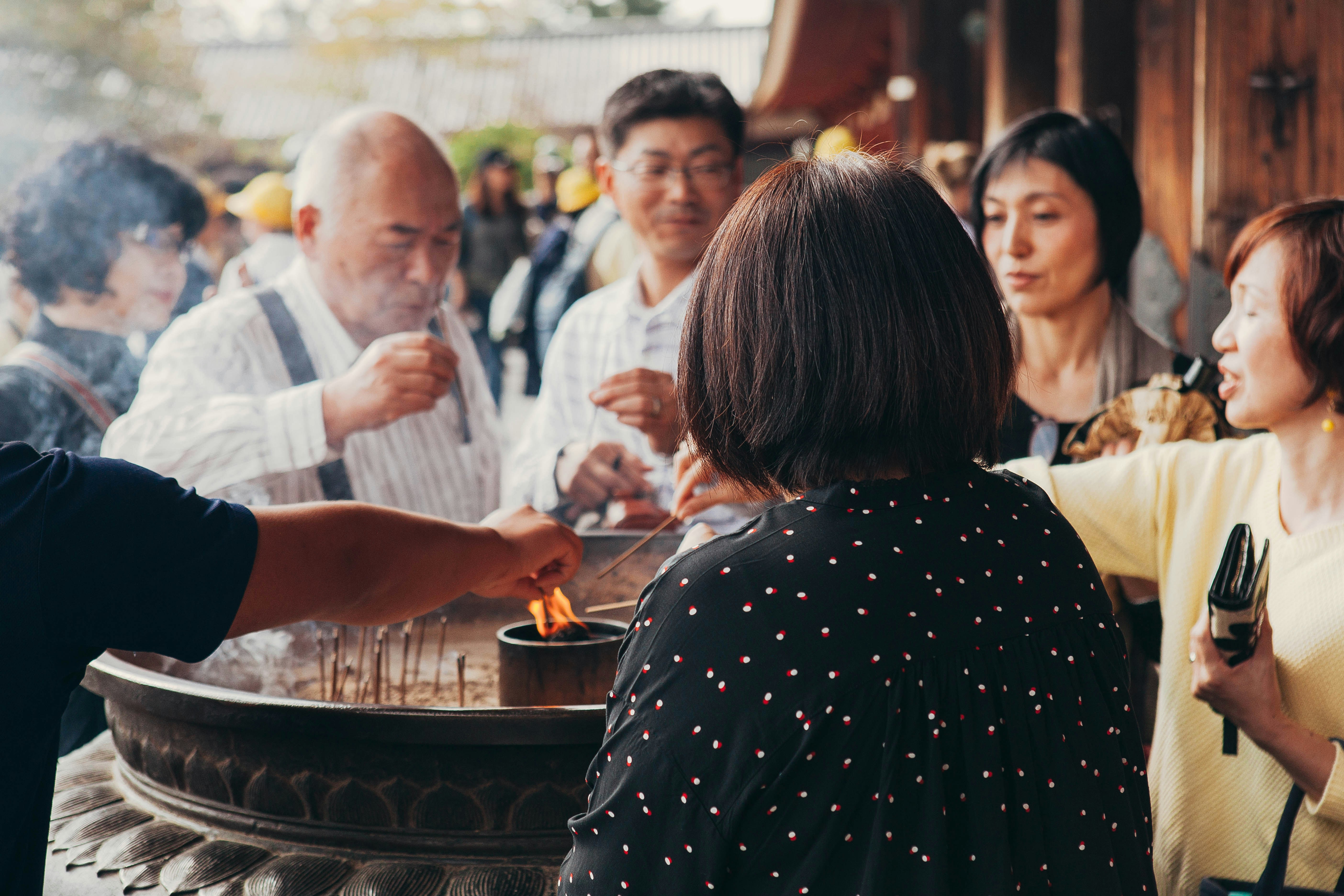 Diverse group of people laughing and talking at a Meetup event in a cafe in Japan