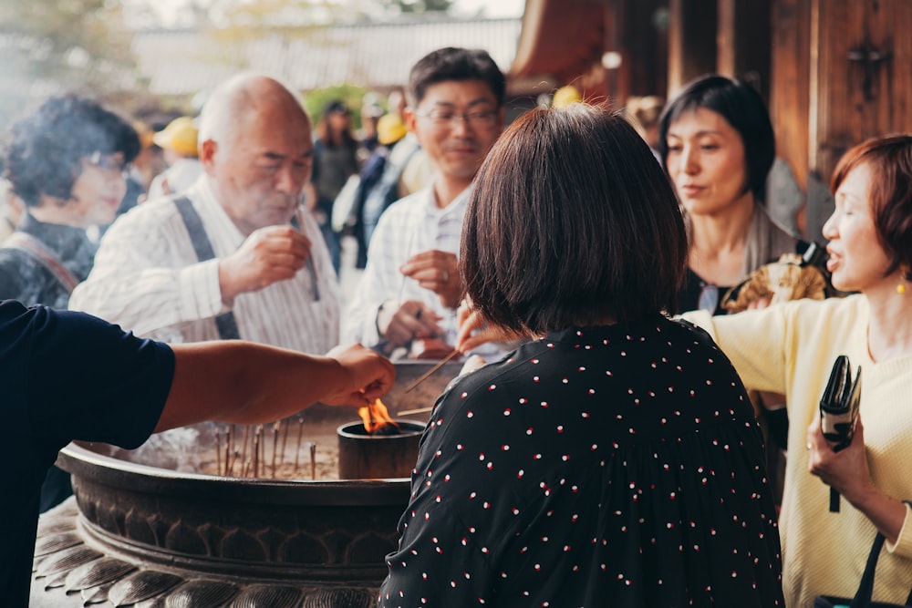 people lighting the stick during daytime