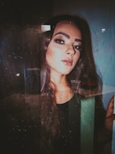 A close-up of a woman with glossy, flowing hair extensions styled elegantly in a modern, chic setting.