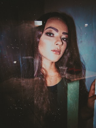 A close-up of a woman with glossy, flowing hair extensions styled elegantly in a modern, chic setting.