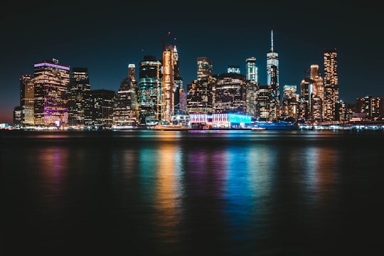 city with lights turned-on during nighttime in Brooklyn Bridge Park United States