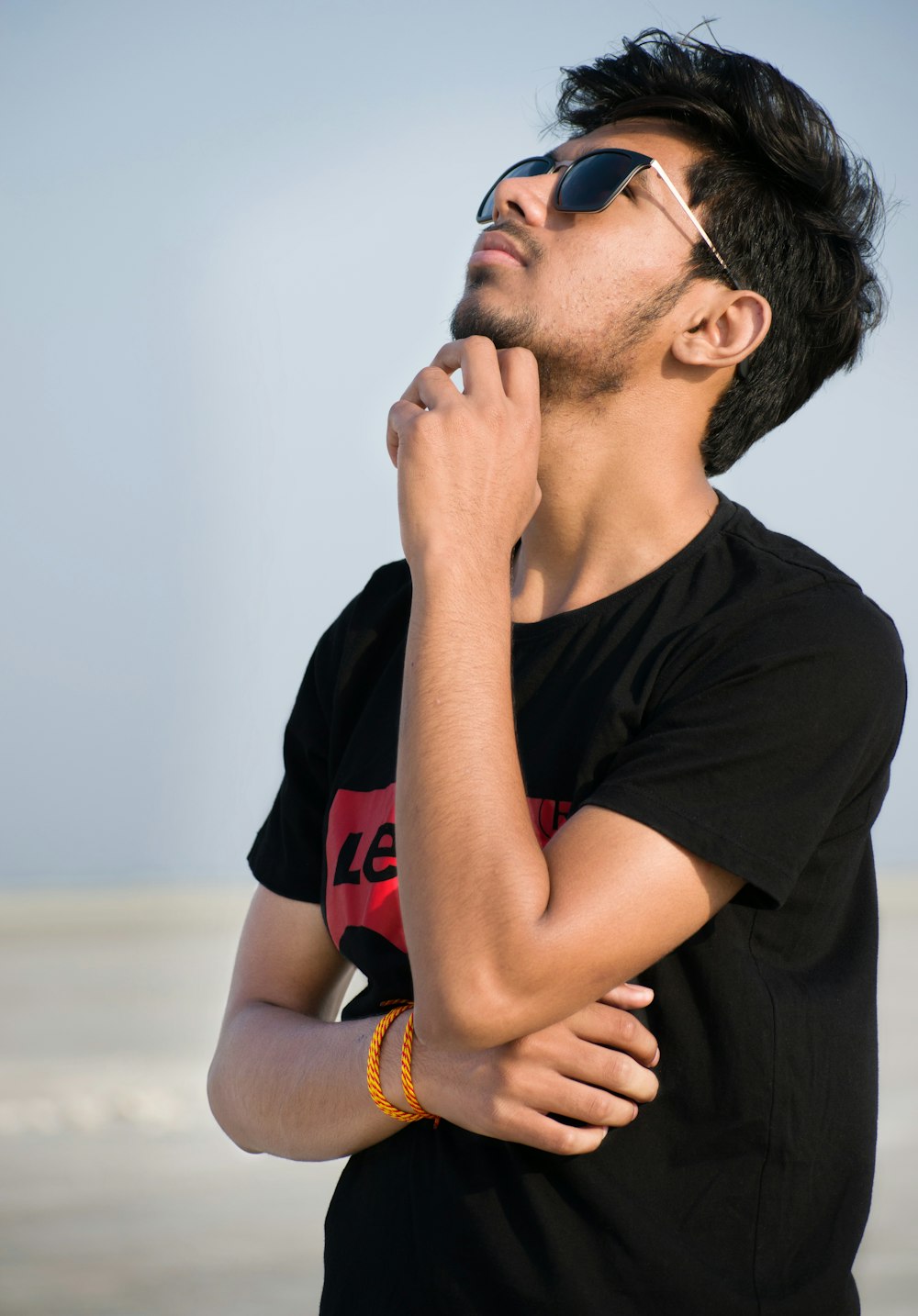 man in black Levi's t-shirt looking up