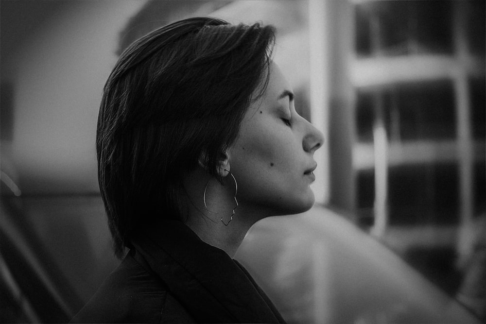 grayscale photo of woman with eyes closed