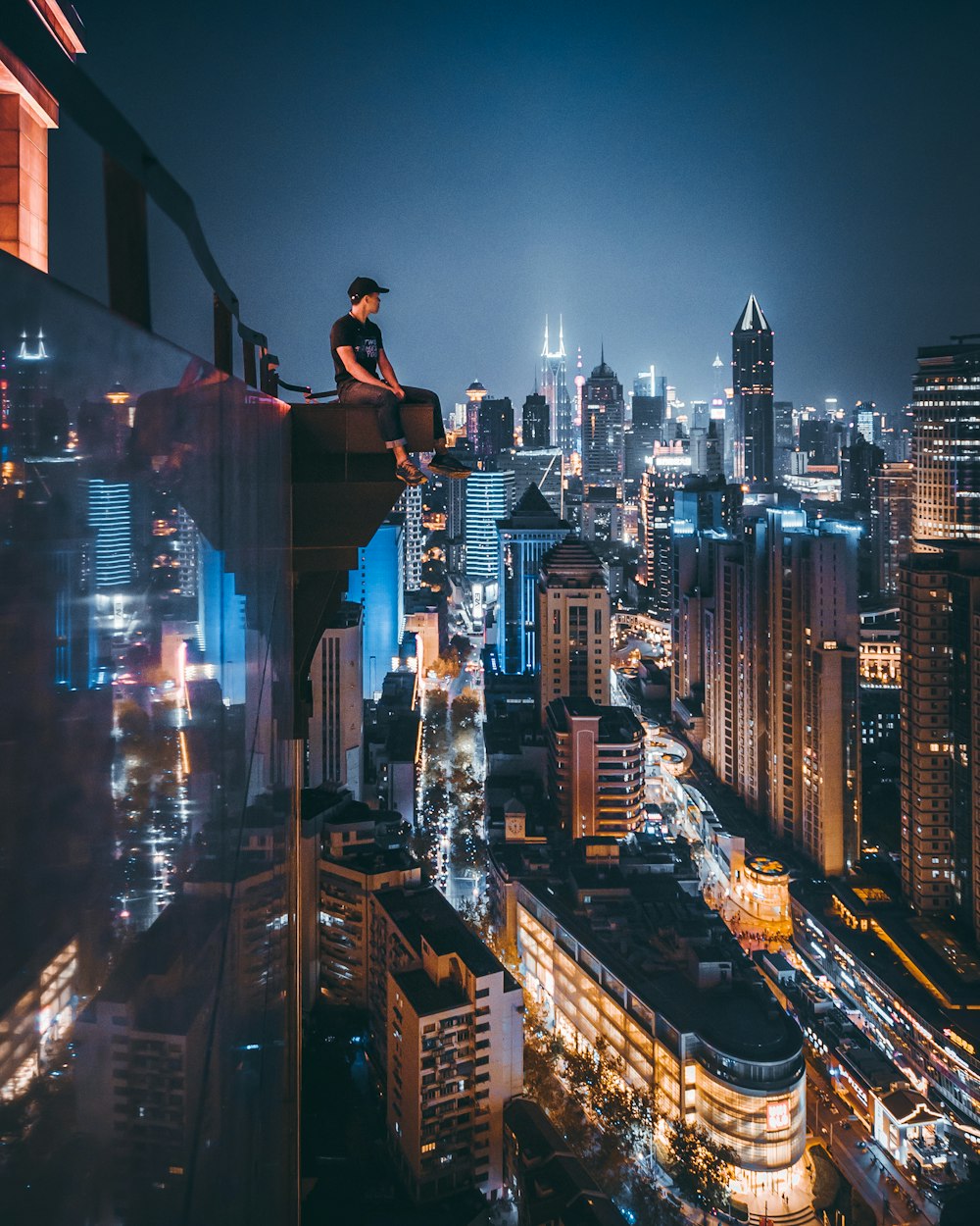 man sitting on top of building