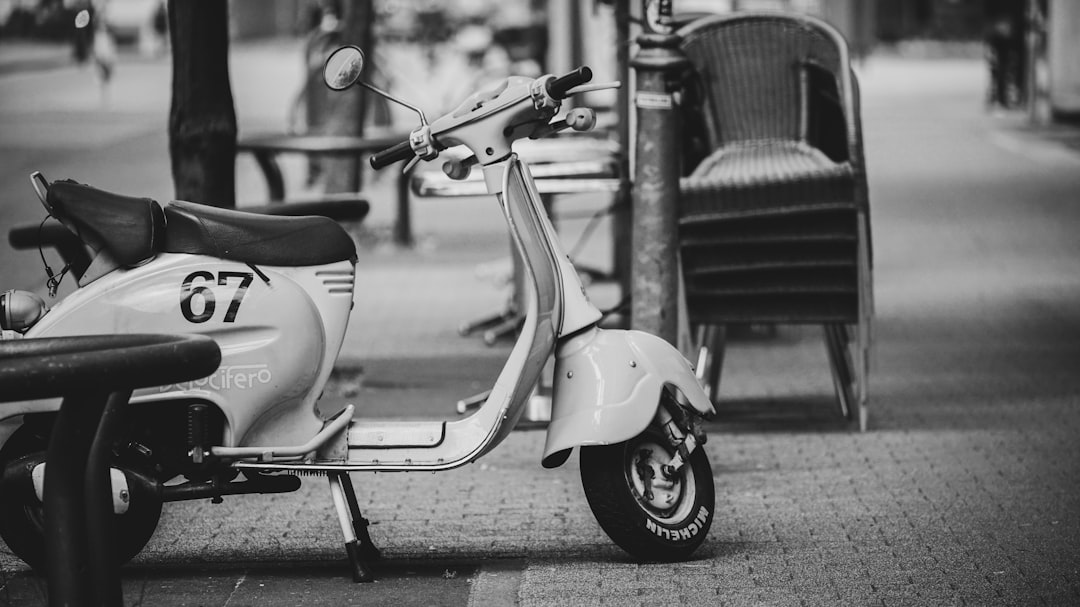 grayscale photography of motor scooter
