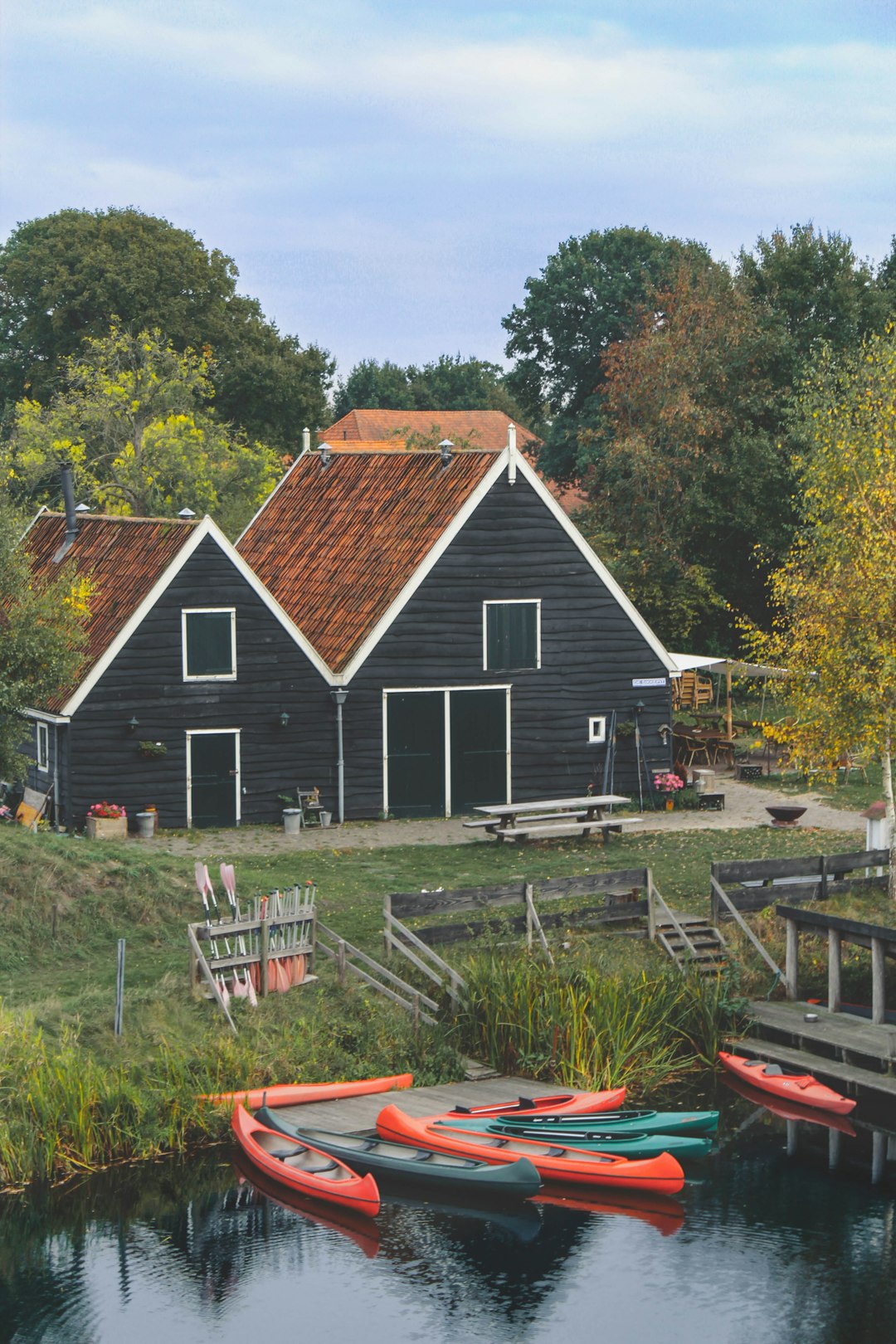black and brown house near boats on river