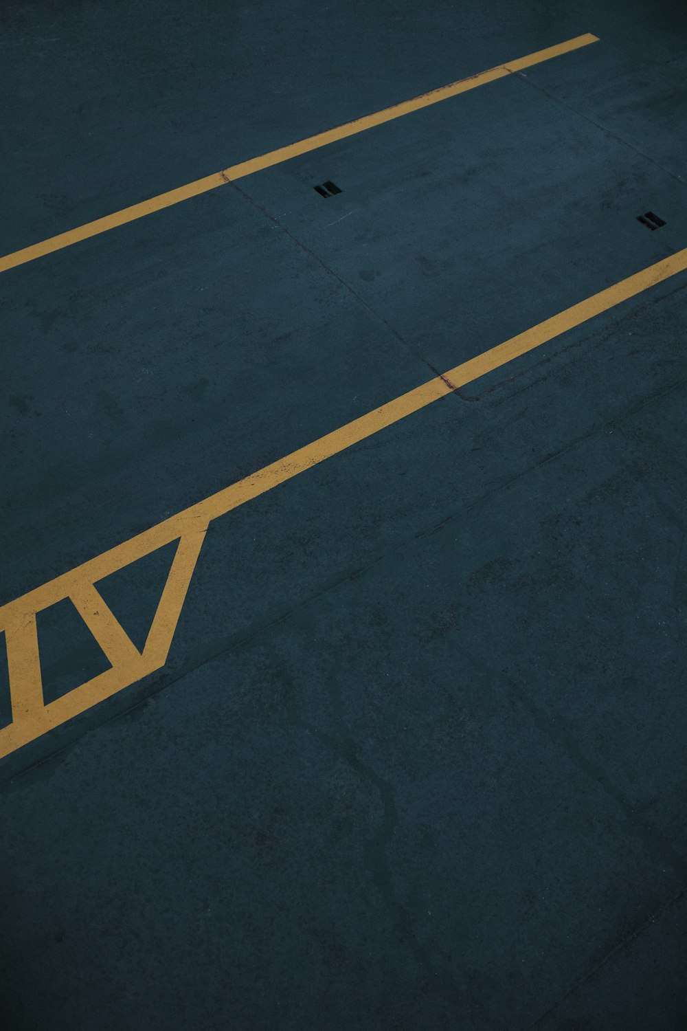 a parking lot with a stop sign painted on it