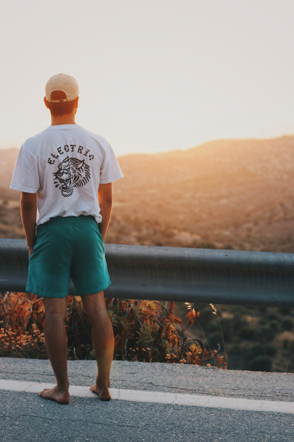 man standing on road