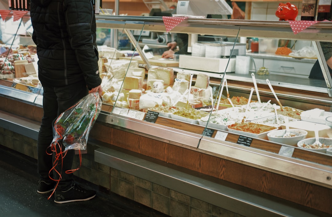man with bouquet of roses standing in front of food display, Romantic meal
