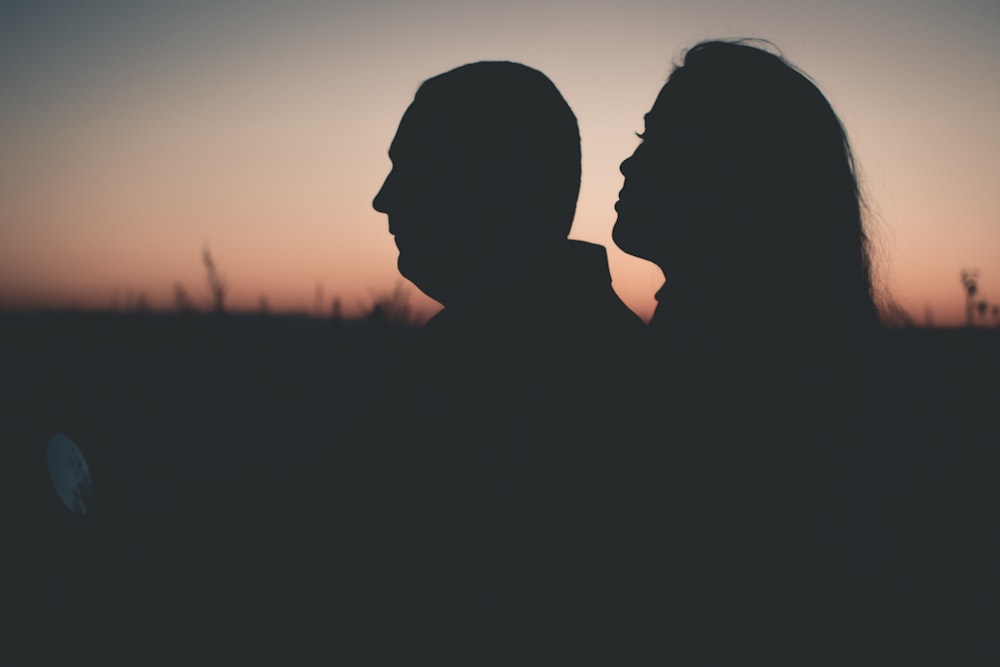 silhouette photography of man and woman