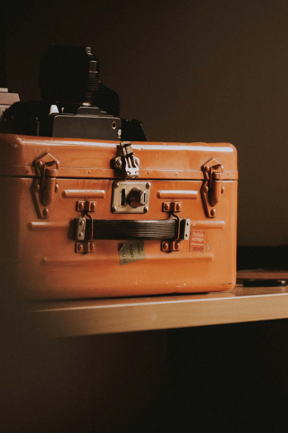 brown suitcase on top of table